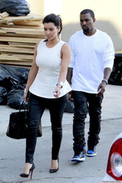 Kim Kardashian and Kanye West are spotted leaving Kanye's house in Los Angeles wearing coordinating white tops and leather pants